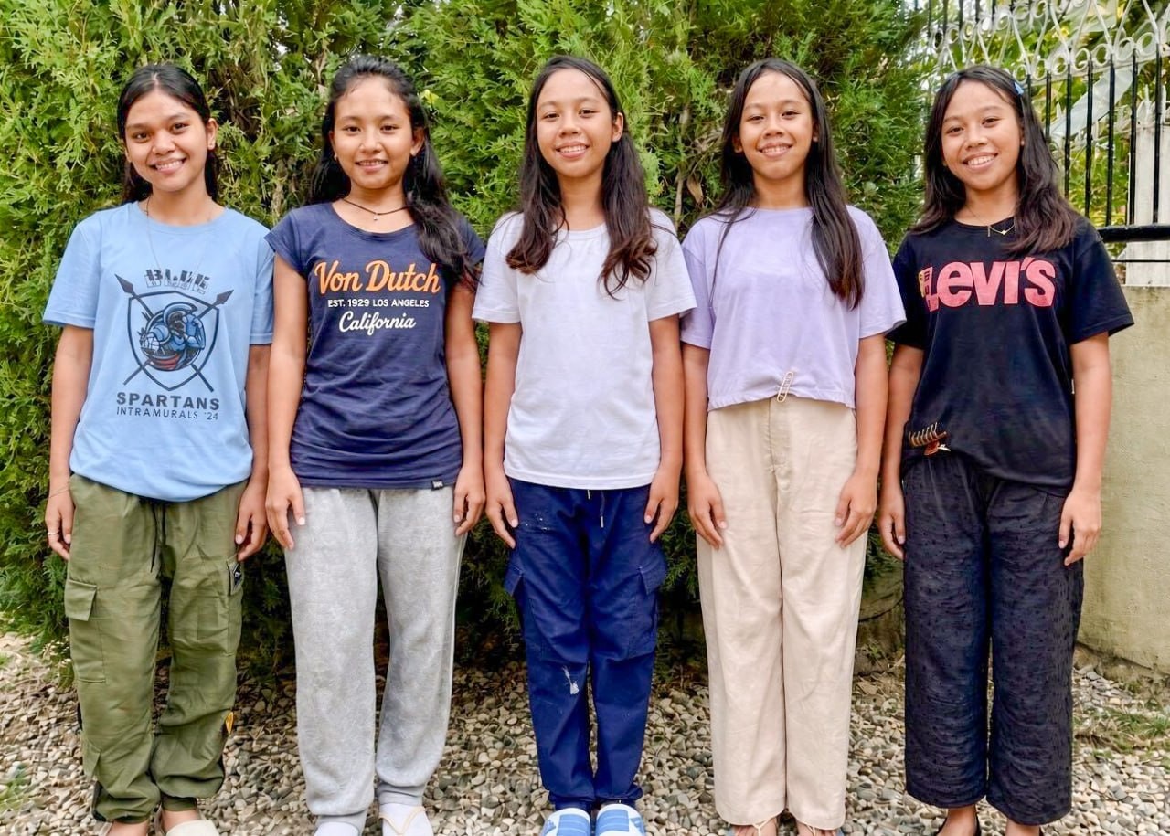 Five girls at the Cebu Girls Home stand together outdoors.