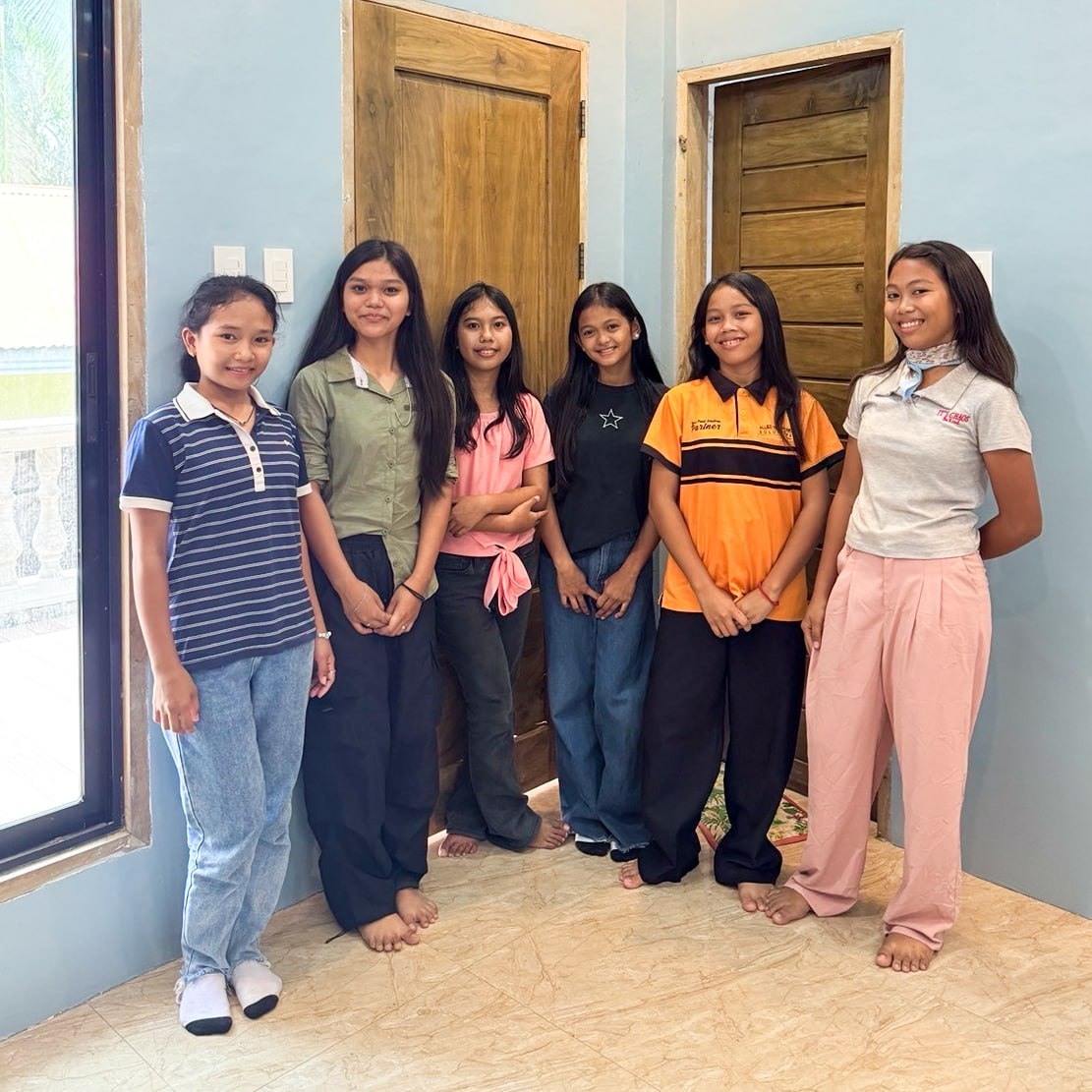 Girls from the Cebu Girls Home gather together outdoors.